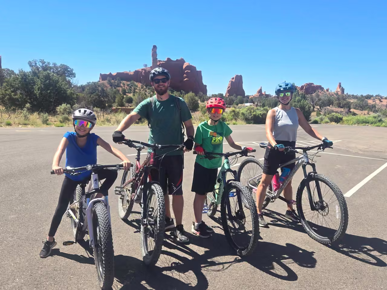 Family with mountain bikes in front of sandstone spires at Kodachrome Basin State Park, Utah