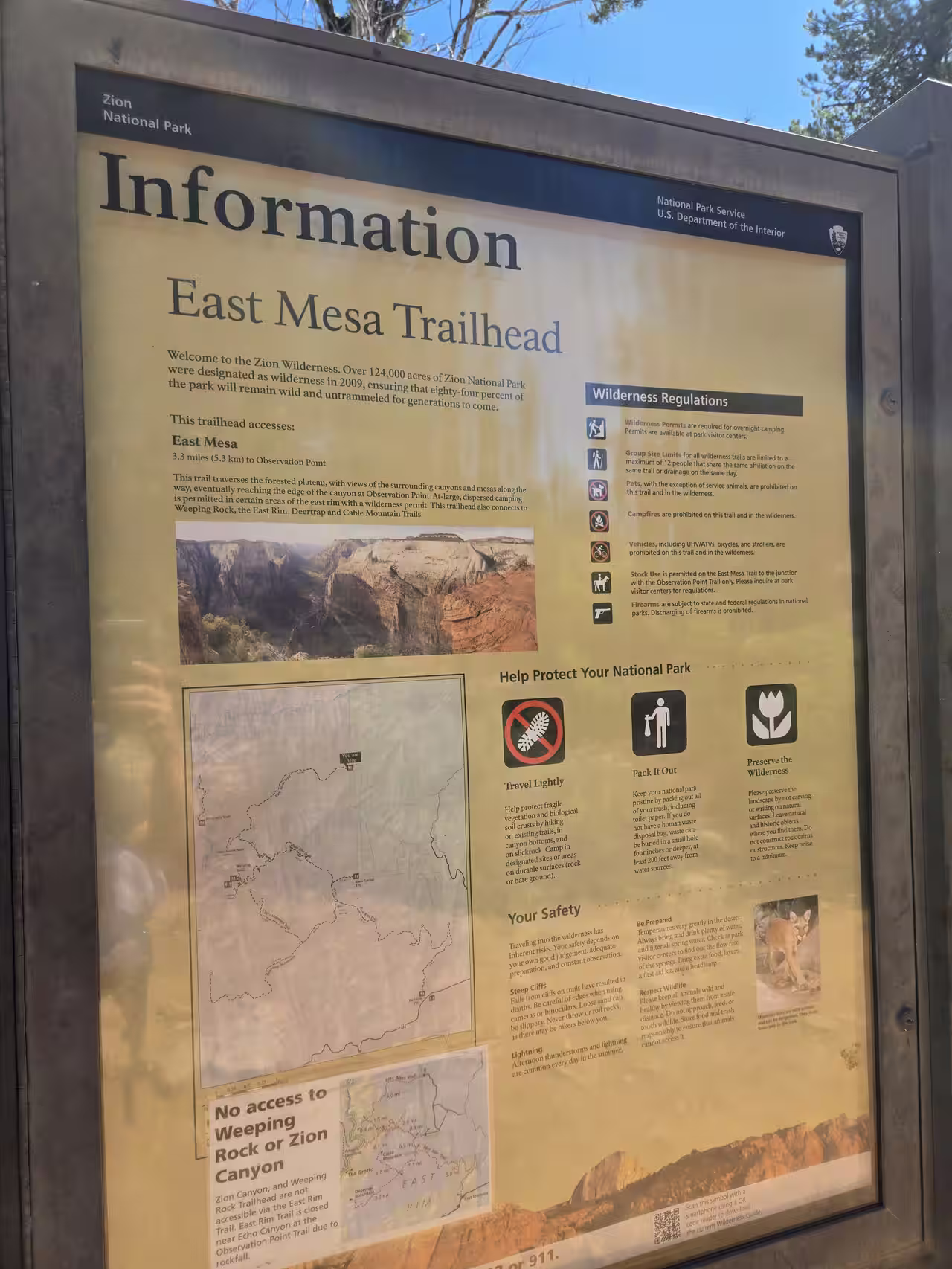 Official NPS East Mesa Trailhead information sign showing distance, wilderness regulations, and trail connections