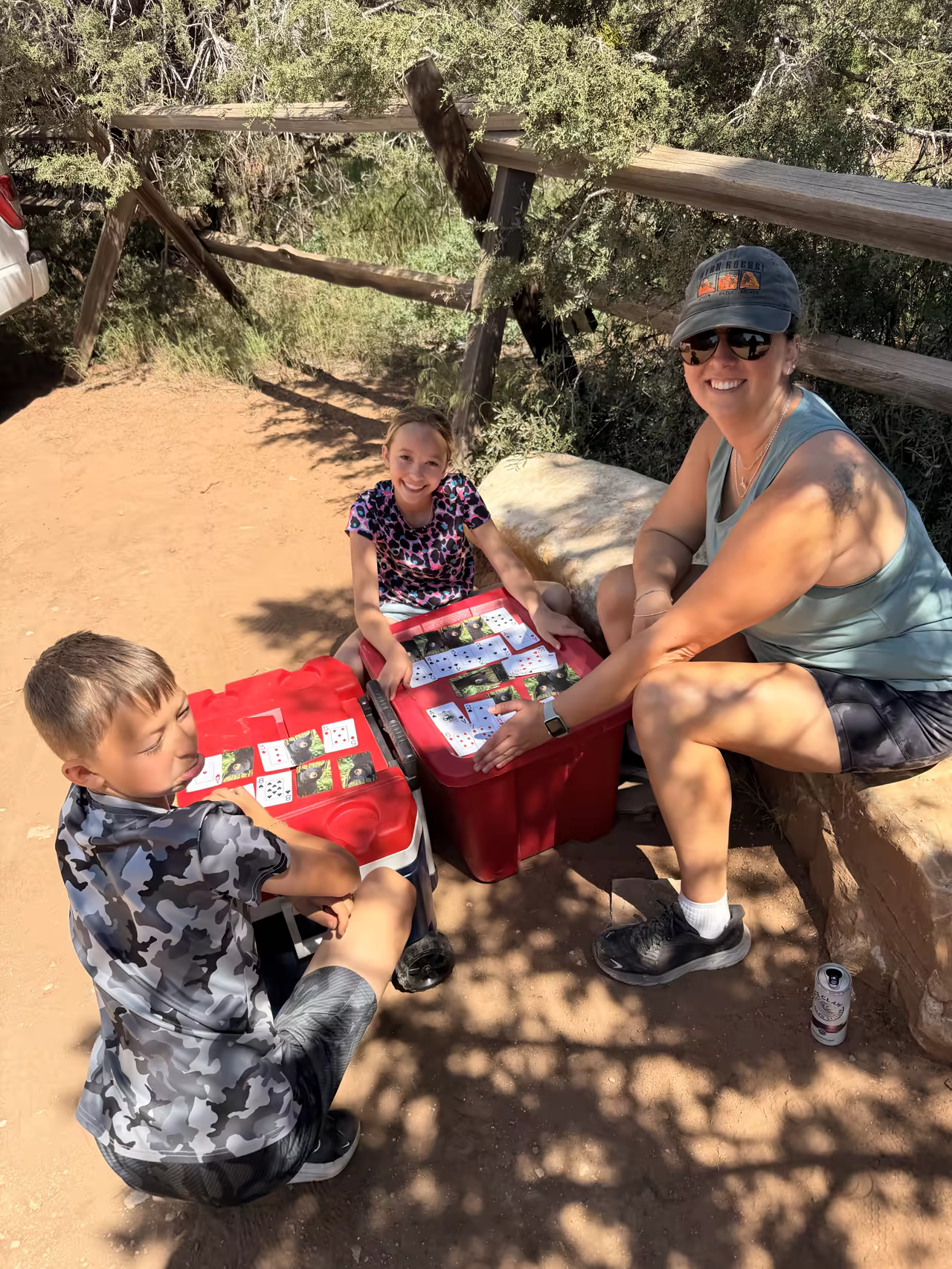 Kids playing a card game at the East Mesa Trailhead while waiting for the rest of the group